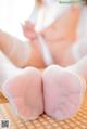 A close up of a woman's feet in white stockings.