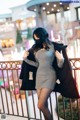 A woman wearing a face mask standing on a balcony.