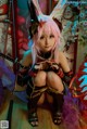 A woman with pink hair wearing bunny ears and holding a sword.