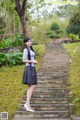 A woman standing on a set of stairs in a park.